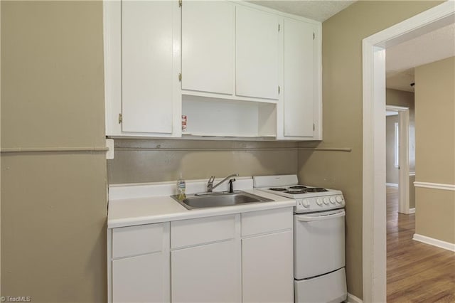 kitchen with white cabinetry, sink, white range with electric stovetop, and light hardwood / wood-style flooring