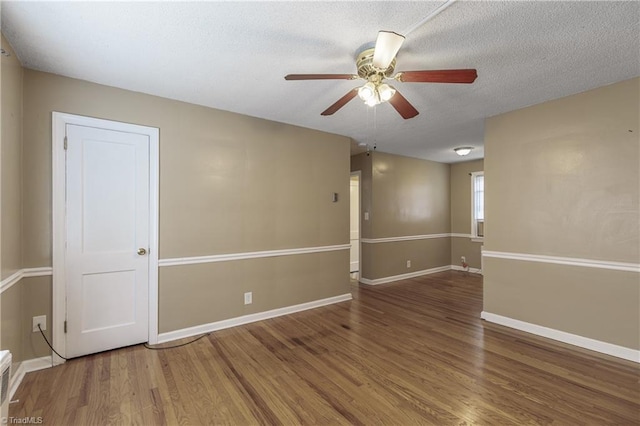 spare room with hardwood / wood-style flooring, ceiling fan, and a textured ceiling