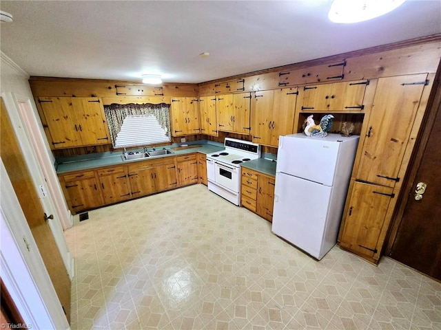 3015 S NC Highway 87, Graham, NC 27253 - kitchen with white appliances, a sink, light floors, crown molding, and brown cabinetry