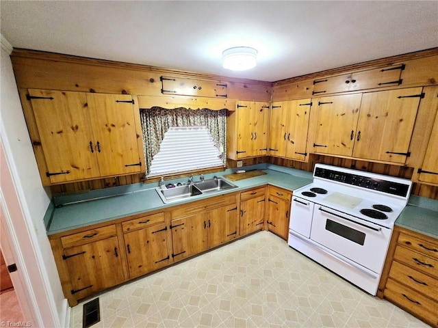 3015 S NC Highway 87, Graham, NC 27253 - kitchen featuring white electric range oven, a sink, and brown cabinets