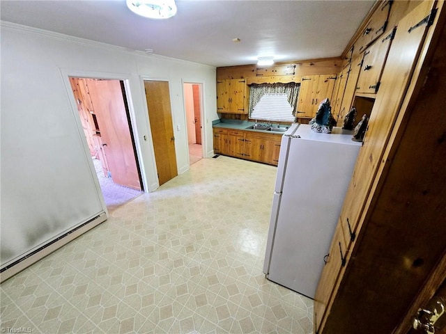 3015 S NC Highway 87, Graham, NC 27253 - clothes washing area with baseboard heating, a sink, light floors, and ornamental molding