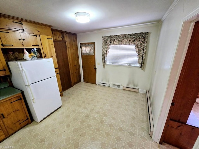 3015 S NC Highway 87, Graham, NC 27253 - kitchen featuring freestanding refrigerator, ornamental molding, a baseboard heating unit, baseboard heating, and light flooring
