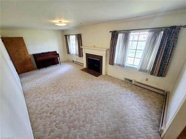 3015 S NC Highway 87, Graham, NC 27253 - unfurnished living room with a fireplace, a baseboard heating unit, carpet flooring, baseboard heating, and crown molding