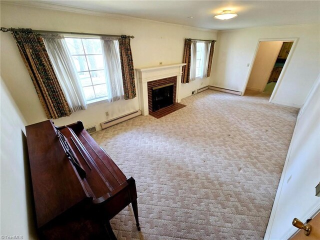 3015 S NC Highway 87, Graham, NC 27253 - carpeted living room featuring a baseboard heating unit, healthy amount of natural light, a fireplace, and ornamental molding