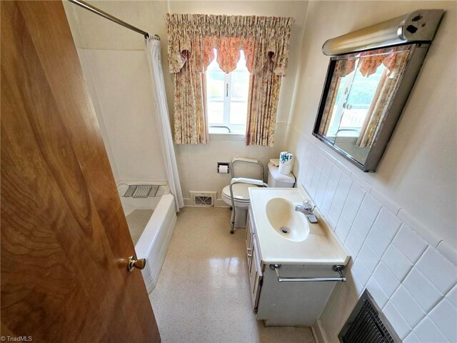 3015 S NC Highway 87, Graham, NC 27253 - bathroom featuring toilet, curtained shower, tile walls, vanity, and a wainscoted wall