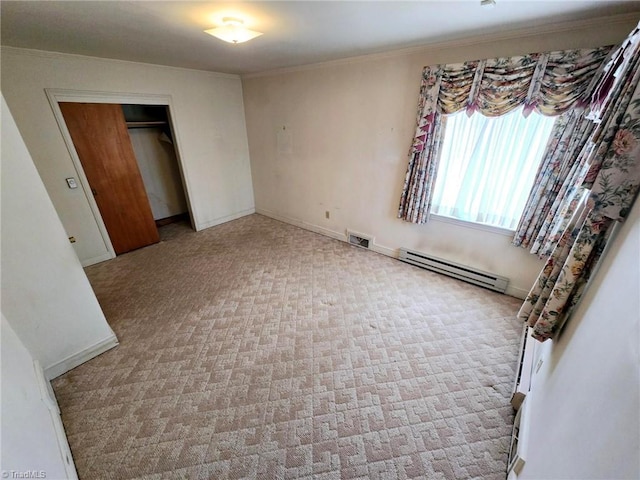 3015 S NC Highway 87, Graham, NC 27253 - unfurnished bedroom featuring a baseboard radiator, crown molding, a closet, carpet flooring, and baseboards