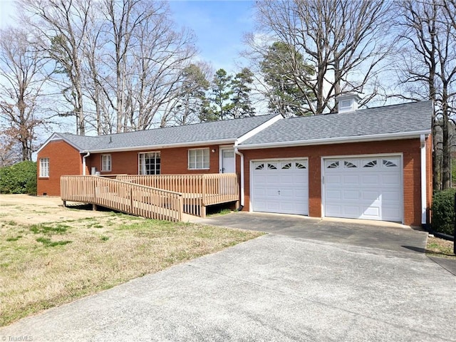 3015 S NC Highway 87, Graham, NC 27253 - ranch-style home featuring brick siding, a garage, driveway, a deck, and a front yard