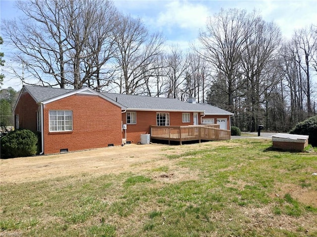 3015 S NC Highway 87, Graham, NC 27253 - rear view of house featuring brick siding, a lawn, a deck, and central AC