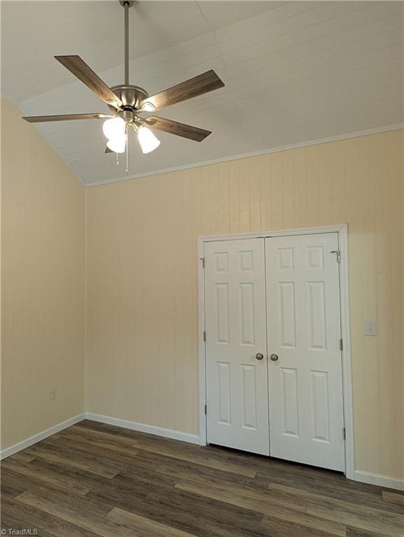 unfurnished bedroom featuring crown molding, a closet, and dark wood finished floors