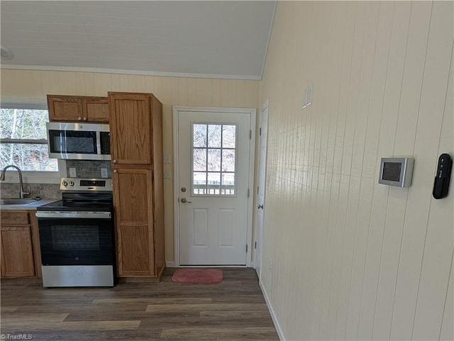 kitchen with plenty of natural light, brown cabinets, a sink, and appliances with stainless steel finishes