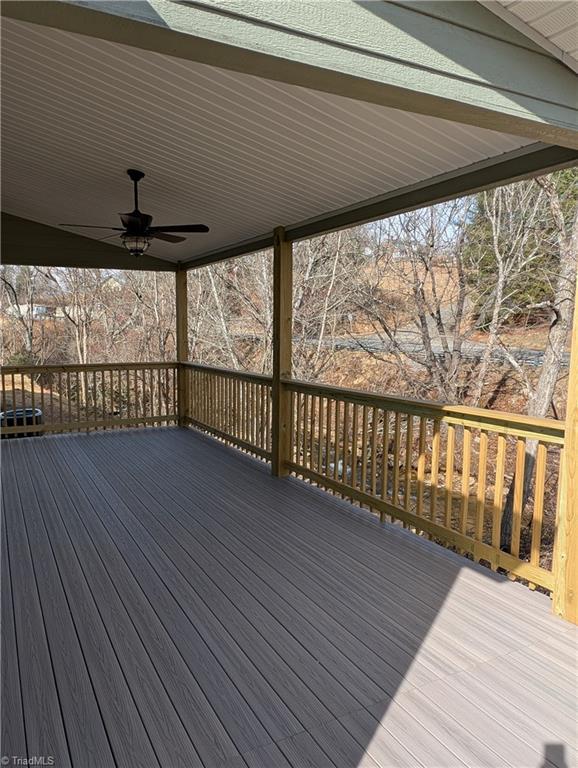wooden deck featuring a ceiling fan
