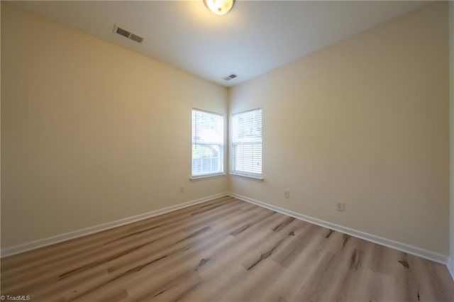 unfurnished room with light hardwood / wood-style flooring