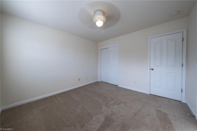 unfurnished bedroom featuring light colored carpet and ceiling fan