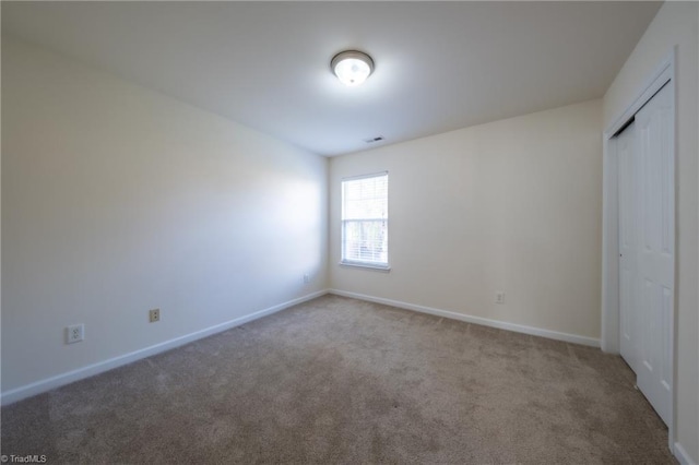 unfurnished bedroom with carpet flooring and a closet