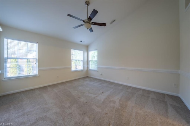 spare room with ceiling fan, light carpet, and high vaulted ceiling