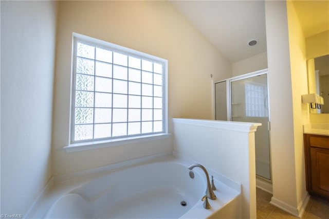 bathroom with tile patterned floors, vanity, vaulted ceiling, and independent shower and bath