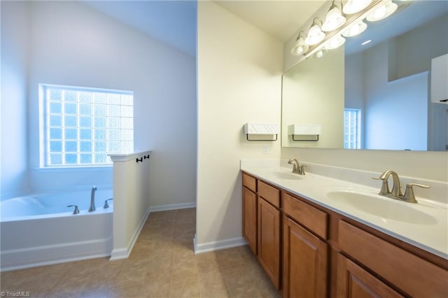 bathroom featuring tile patterned flooring, vanity, and a tub to relax in