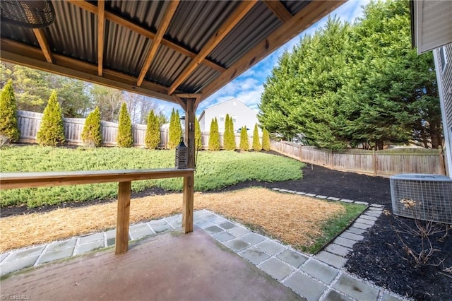 view of yard featuring central air condition unit and a patio area