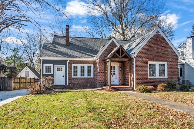 view of front of house with a front yard and central AC