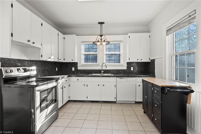 kitchen with electric range, sink, white dishwasher, hanging light fixtures, and white cabinets