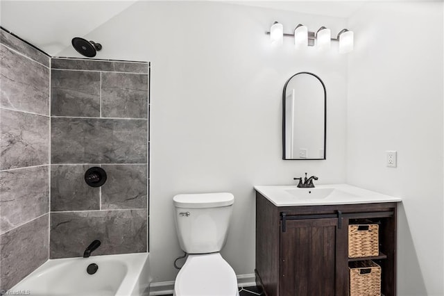 full bathroom featuring toilet, tiled shower / bath, and vanity