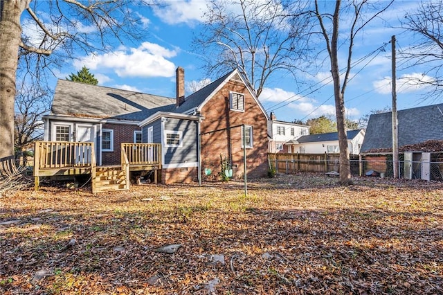 rear view of property with a wooden deck