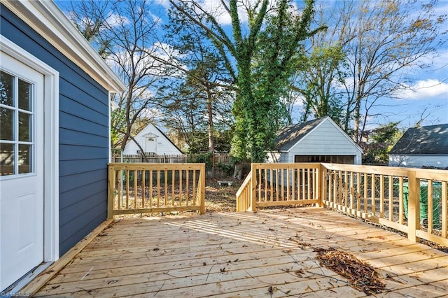 deck with a garage and an outbuilding