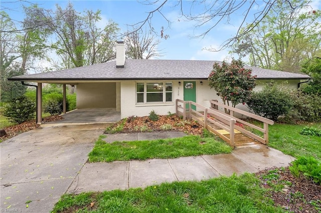 5170 Sunrise Ter, Winston-Salem, NC 27105 - ranch-style home with brick siding, an attached carport, driveway, and a chimney