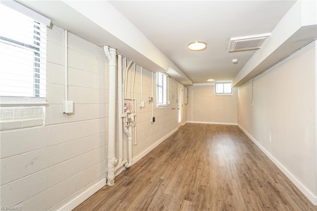 5170 Sunrise Ter, Winston-Salem, NC 27105 - basement with visible vents, baseboards, concrete block wall, and wood finished floors
