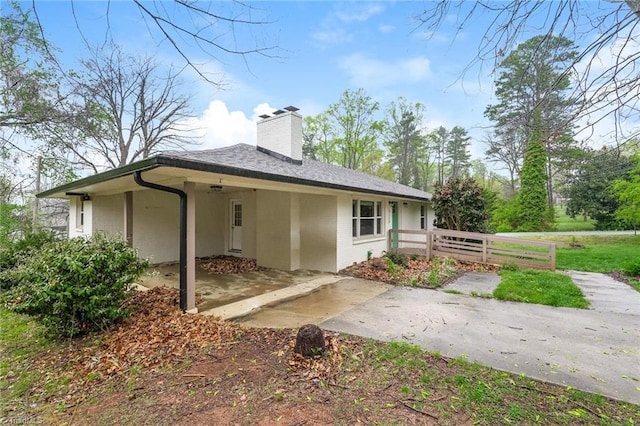 5170 Sunrise Ter, Winston-Salem, NC 27105 - back of house with a chimney, fence, a patio, concrete driveway, and an attached carport