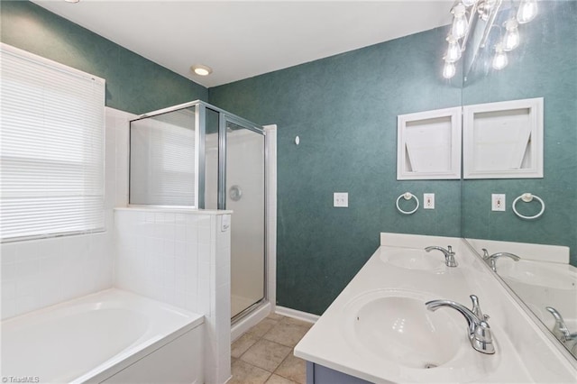 bathroom with a shower stall, a sink, and tile patterned floors