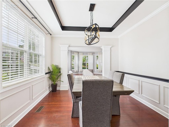 1728 Callandale Ave, Cary, NC 27518 - dining room featuring ornate columns, a decorative wall, a chandelier, dark wood-type flooring, and a raised ceiling
