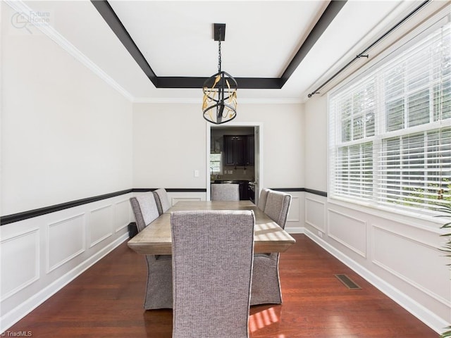 1728 Callandale Ave, Cary, NC 27518 - dining room featuring a tray ceiling, a decorative wall, dark wood finished floors, a chandelier, and a wainscoted wall
