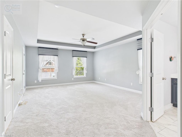 1728 Callandale Ave, Cary, NC 27518 - empty room with a ceiling fan, a tray ceiling, baseboards, and light carpet
