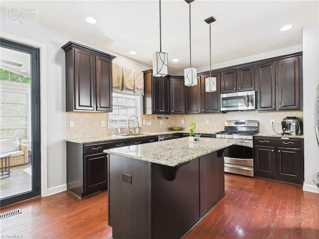 1728 Callandale Ave, Cary, NC 27518 - kitchen with appliances with stainless steel finishes, dark brown cabinetry, dark wood-type flooring, healthy amount of natural light, and recessed lighting