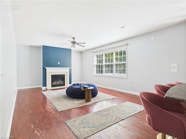 1728 Callandale Ave, Cary, NC 27518 - living area with hardwood / wood-style flooring, ceiling fan, baseboards, and a glass covered fireplace