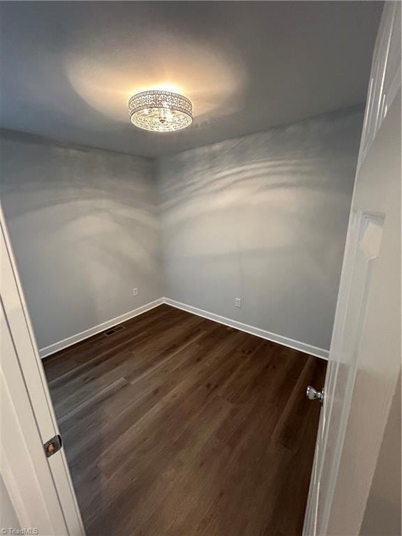 empty room with dark wood-type flooring