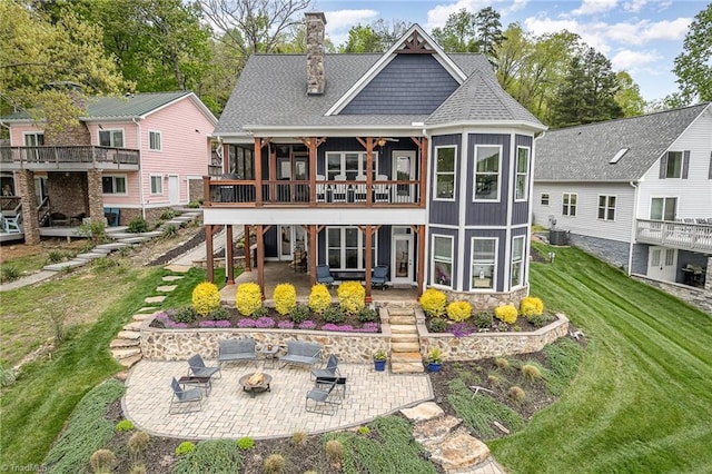 602 Shoreline Rd, New London, NC 28127 - back of property with an outdoor fire pit, a patio area, a lawn, and a chimney