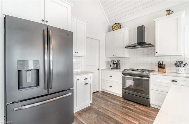 602 Shoreline Rd, New London, NC 28127 - kitchen featuring appliances with stainless steel finishes, wall chimney range hood, lofted ceiling, white cabinetry, and light countertops