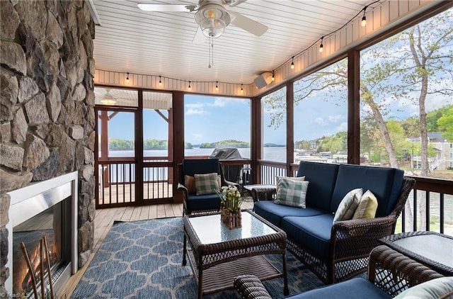 602 Shoreline Rd, New London, NC 28127 - sunroom with an outdoor living space with a fireplace, track lighting, a ceiling fan, and a water view