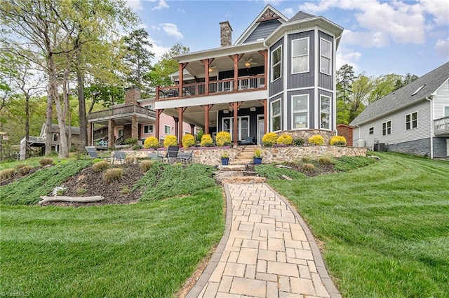 602 Shoreline Rd, New London, NC 28127 - back of house with a lawn, a chimney, cooling unit, board and batten siding, and ceiling fan