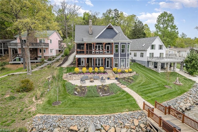 602 Shoreline Rd, New London, NC 28127 - back of property featuring stairway, a chimney, a wooden deck, and a lawn