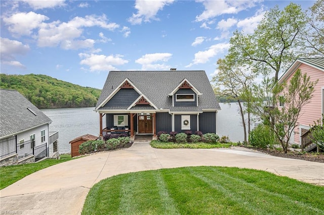 602 Shoreline Rd, New London, NC 28127 - craftsman inspired home featuring a porch, a water view, a front yard, and roof with shingles