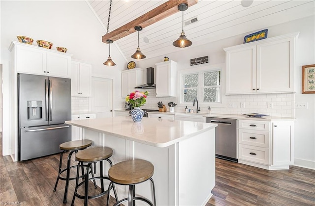 602 Shoreline Rd, New London, NC 28127 - kitchen featuring stainless steel appliances, wall chimney range hood, a sink, white cabinets, and a kitchen island