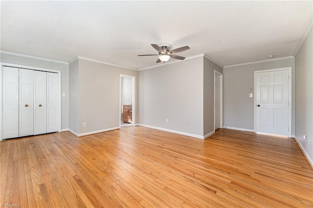 interior space featuring ornamental molding, light wood finished floors, a ceiling fan, and baseboards