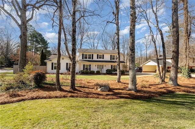 view of front of property with a porch, fence, and a front lawn