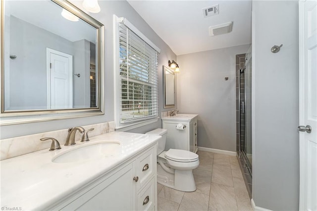 full bath featuring toilet, two vanities, a sink, visible vents, and a shower stall