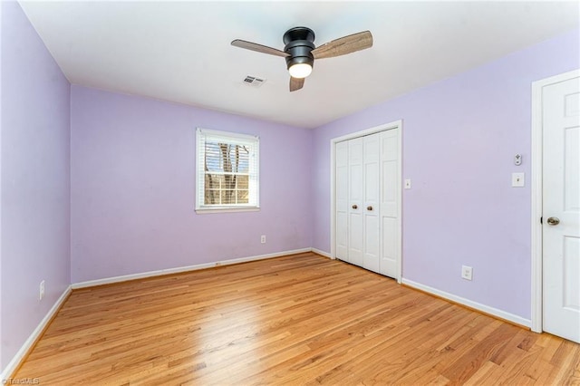 unfurnished bedroom featuring baseboards, visible vents, and light wood-style floors