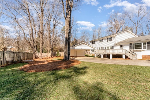 back of property featuring fence, a lawn, and a wooden deck