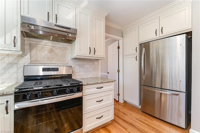 kitchen with light wood-style flooring, appliances with stainless steel finishes, ornamental molding, light stone countertops, and under cabinet range hood